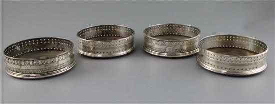 A set of four George III pierced silver wine coasters, probably Robert & David Hennell, 13.3cm.